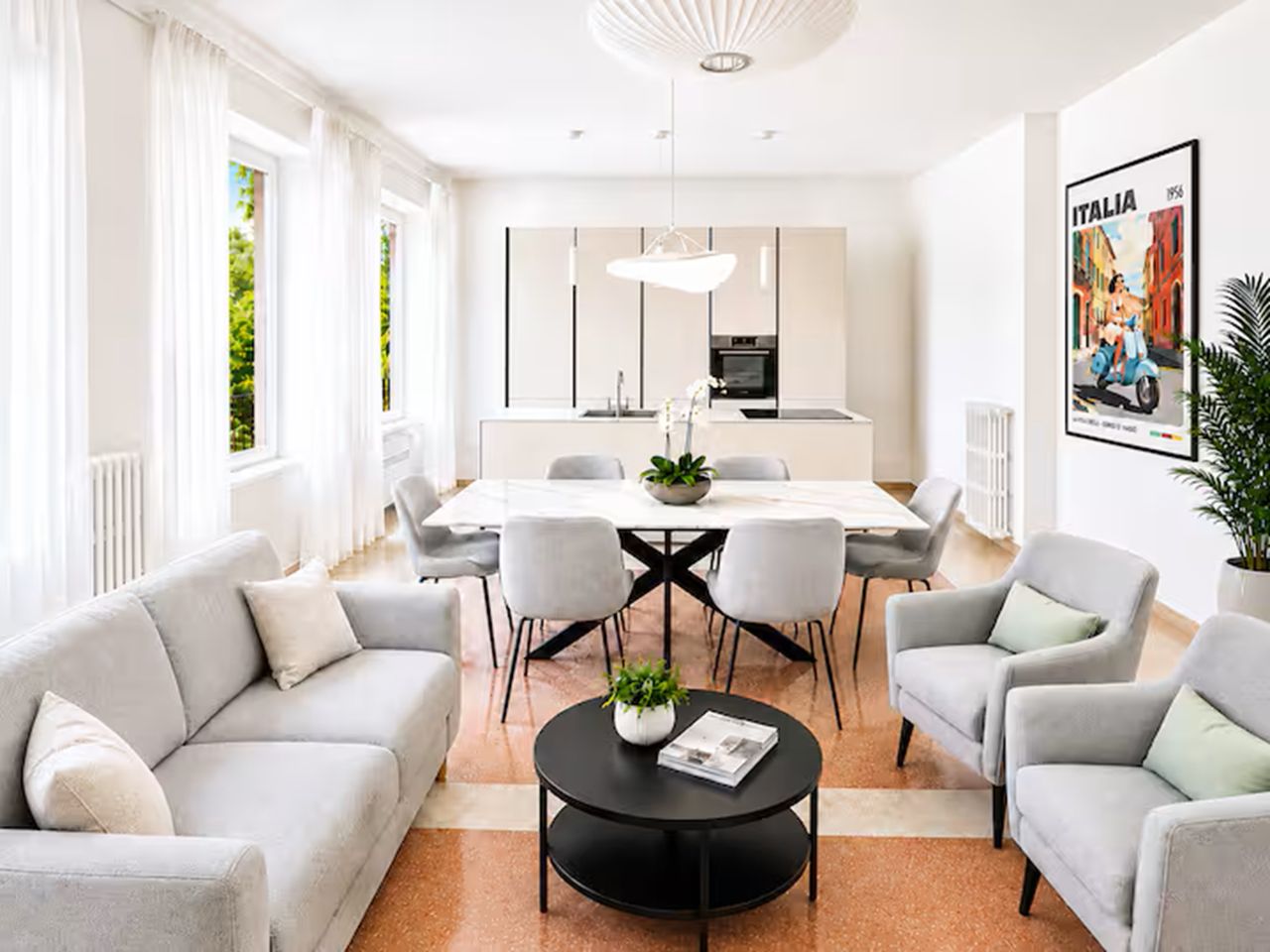 A modern living room with a dining area, featuring a sofa set, a coffee table, and a dining table with chairs.