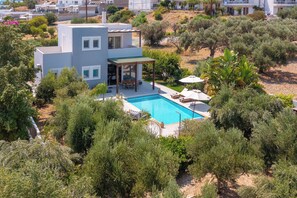A modern house with a swimming pool surrounded by lush greenery. - Villa Olvia - Three Bedroom Villa, Sleeps 6 (Rhodes)