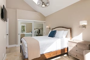 A bedroom with a bed, bedside tables, a wardrobe, and a television. - 25% Off Sept, Perfect For Families, Walk To Beach! (Ventura)