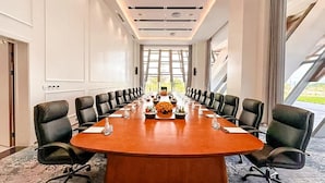 A conference room with a long table, black chairs, and a floral centerpiece. - Arba Minch Conference Resort  (Arba Minch)