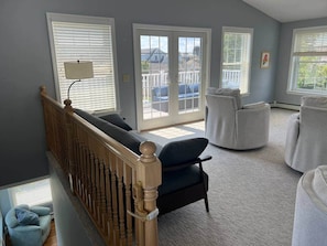 A room with a staircase, a sofa, a chair, and a lamp. - Between the beaches extended family retreat-Gourmet Kitchen (York)
