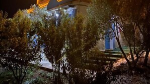 A building at night with illuminated upper levels and a visible balcony. - Olea Azul (chefchaouen)