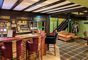 A bar area with stools, a bar counter, and a staircase leading to an upper level. - Chartridge Lodge Hotel (Chartridge)