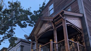 A two-story wooden house with a balcony and a covered porch. - 146-6 Dizzy Gillespe Upper-Level Retreat 2Gather Self		1 Bedroom Studio. (New London)