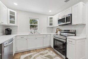 A modern kitchen with white cabinetry, a built-in microwave, an oven, and a dishwasher. - Comfortable coastal living just minutes from Historic Downtown Panama City (Panama City)