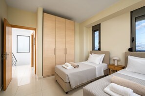 A hotel room with a bed, a bedside table, a lamp, a wardrobe, and a window with a view. - Villa Aqua in Lachania (Lachania)