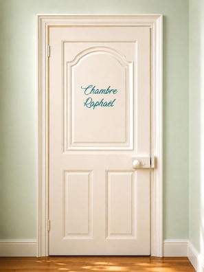 A white door with the name 'Chambre Raphael' in cursive lettering. - La Parenthèse Fléchoise (La Flèche)