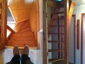 A wooden staircase leading to a lofted area with a sloped ceiling. - Comfortable apartment with parking - 6 guests (Val-d'Isère)