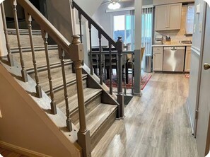 A staircase leading to a dining area with a view of the outdoors.