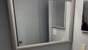A bathroom with a large mirror, a white sink, and a towel on the counter. - Cozy Home Away From Home (Woodbridge)