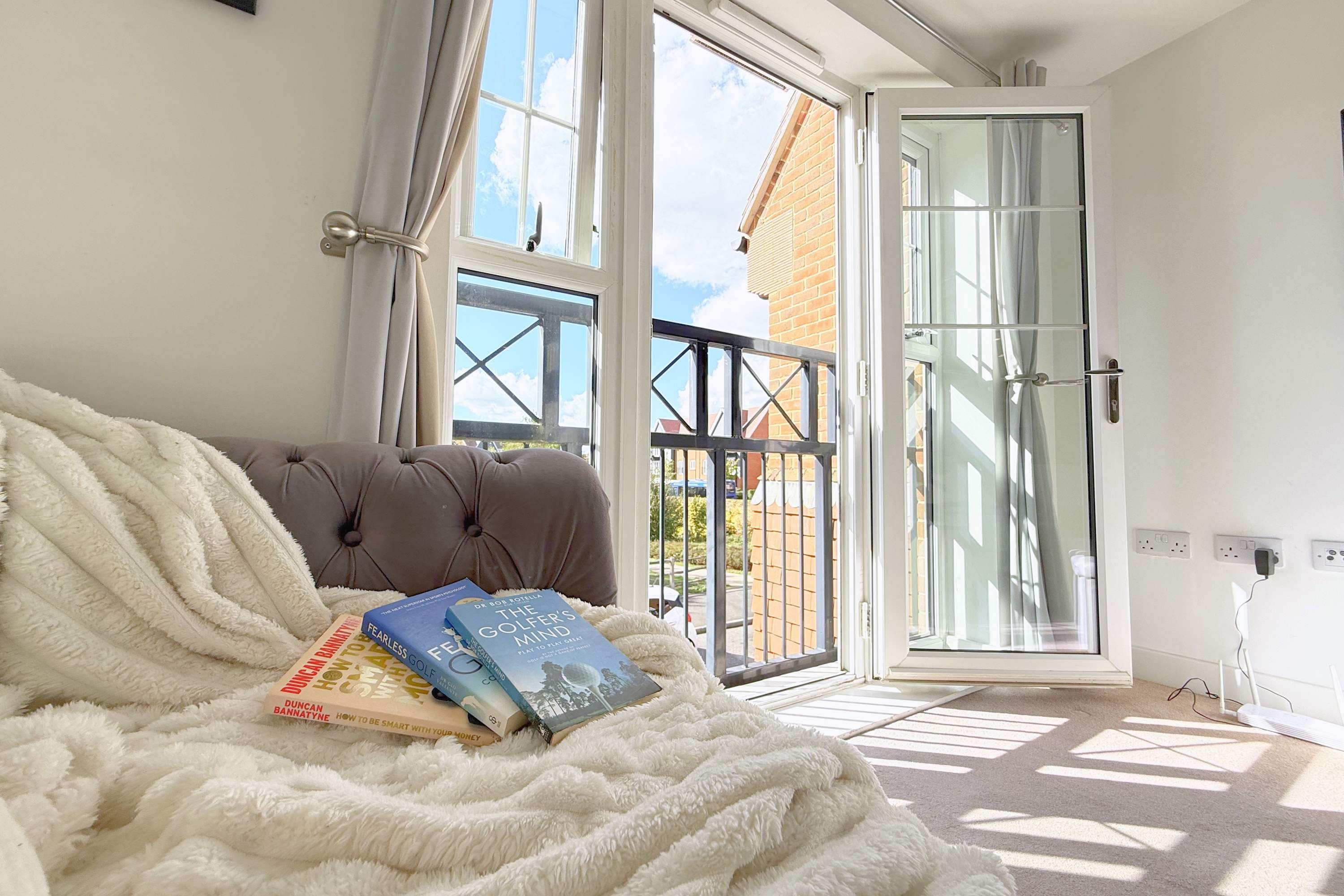 A bedroom with a bed, a window, and a door.