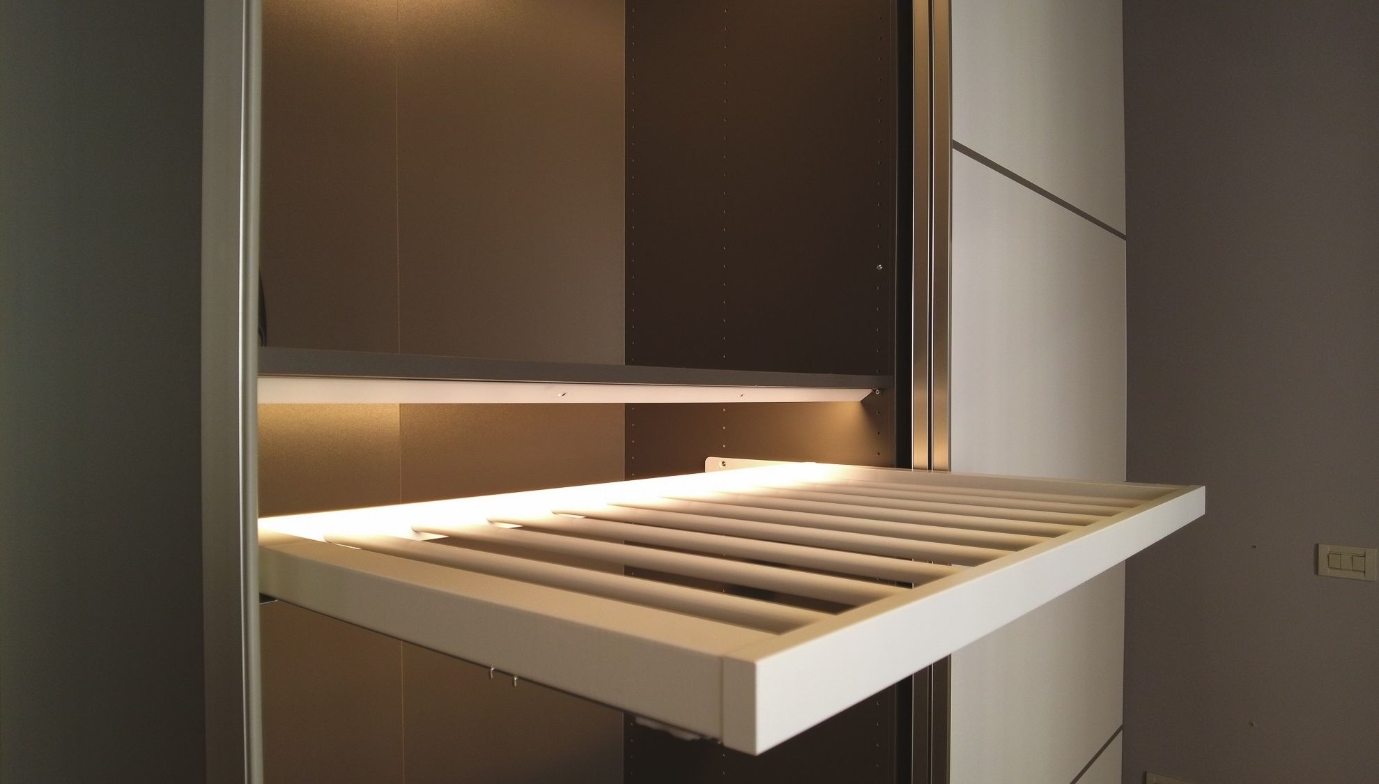 A modern kitchen with a built-in oven and a white countertop.