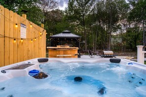 A hot tub area with a wooden deck, a gazebo, and a barbecue grill. - Poconos Home | Hot Tub, Cold Plunge & Fire Pit (Long Pond)
