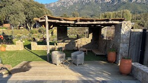 A wooden deck with outdoor furniture, a pergola, and a swimming pool. - Vrbo Property (Carbuccia)