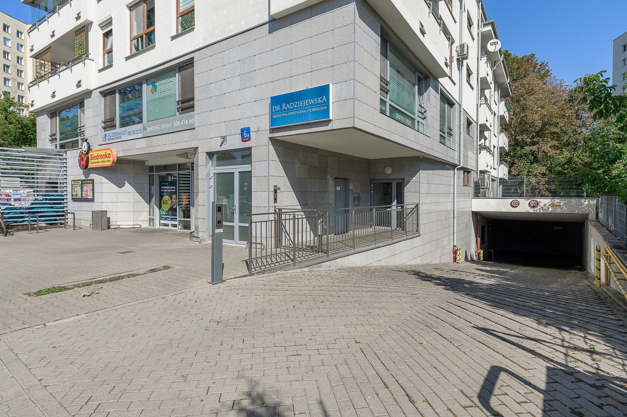 A modern building with a blue sign indicating a medical facility.