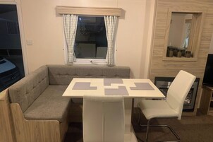 A compact living space with a sofa, a small table, and two chairs.