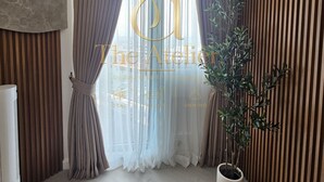A modern room with a large window, a potted plant, and a ceiling-mounted air conditioning unit. - Atelier Azure North | Beach & Wave Pool (San Fernando)