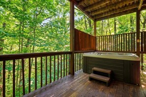 A wooden deck with a hot tub and a bench, surrounded by a forest. - Foliage Heaven! A+ Location! Cabin w/Private HTub (Sevierville)