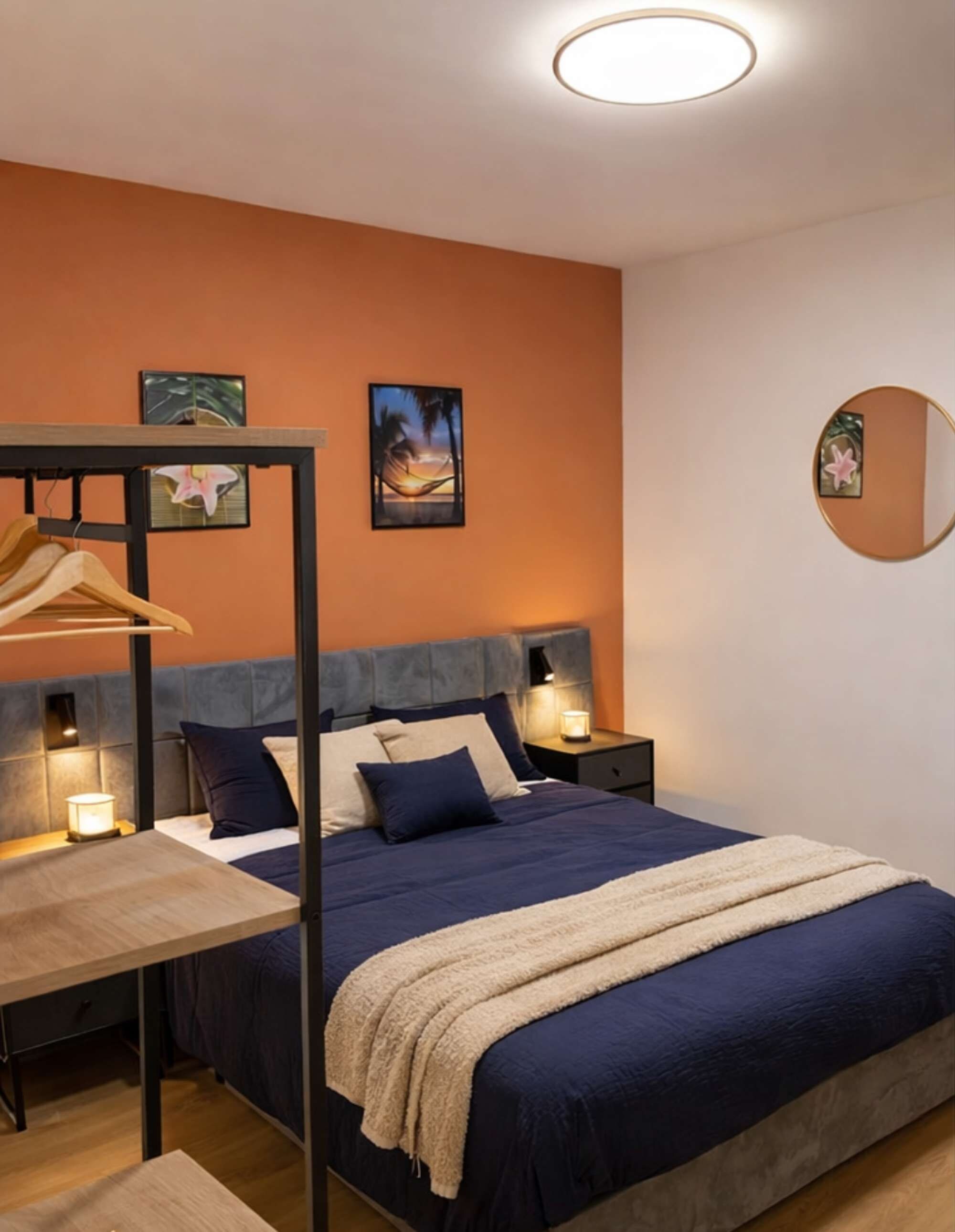 Un dormitorio con cama, mesitas de noche, armario colgado y cuadros en la pared.