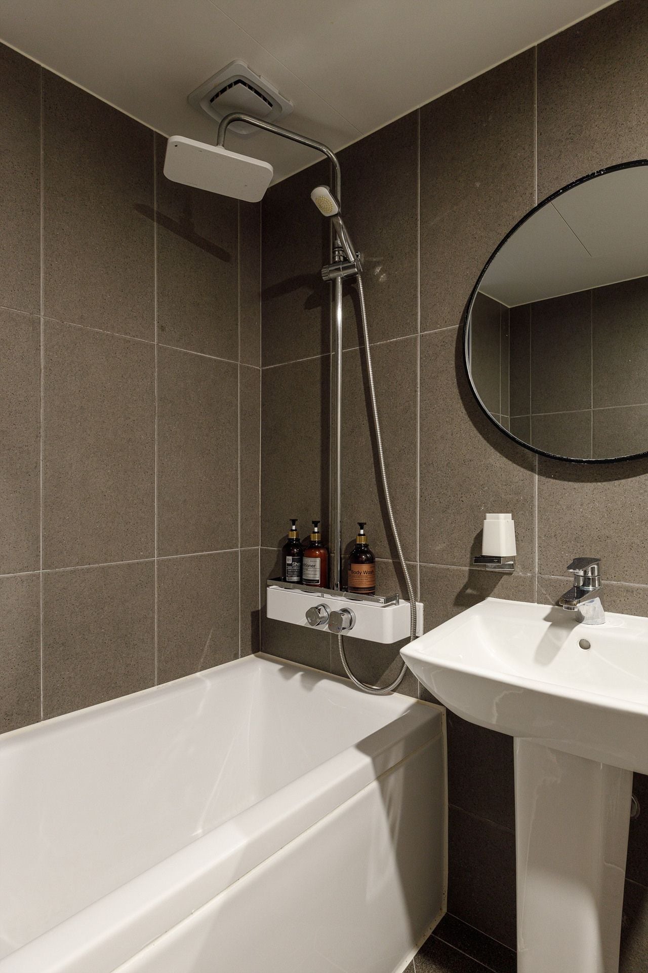 A modern bathroom with a bathtub, a sink, and a shower.