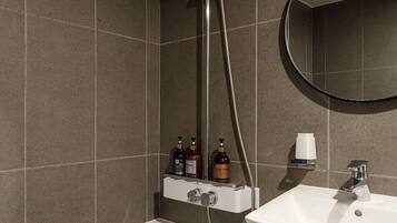 A modern bathroom with a bathtub, a sink, and a shower.