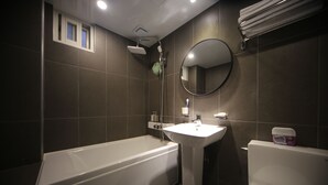 A bathroom with a bathtub, a sink, and a toilet.