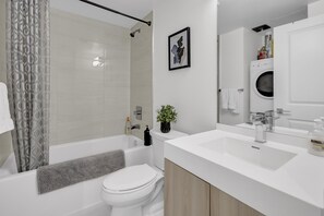 Un bagno moderno con vasca, water e lavandino.
