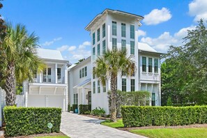 A two-story building with a covered porch and a driveway leading to the entrance. - Private Pool, 4 King En-suites + Bunk Room, Outdoor Fireplace & Kitchen (Santa Rosa Beach)