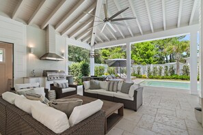 A covered outdoor living area with a barbecue, seating, and a view of a swimming pool. - Private Pool, 4 King En-suites + Bunk Room, Outdoor Fireplace & Kitchen (Santa Rosa Beach)