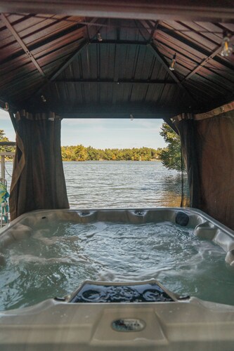 Lakefront vacation home with hot tub, private sandy beach, and fire pit