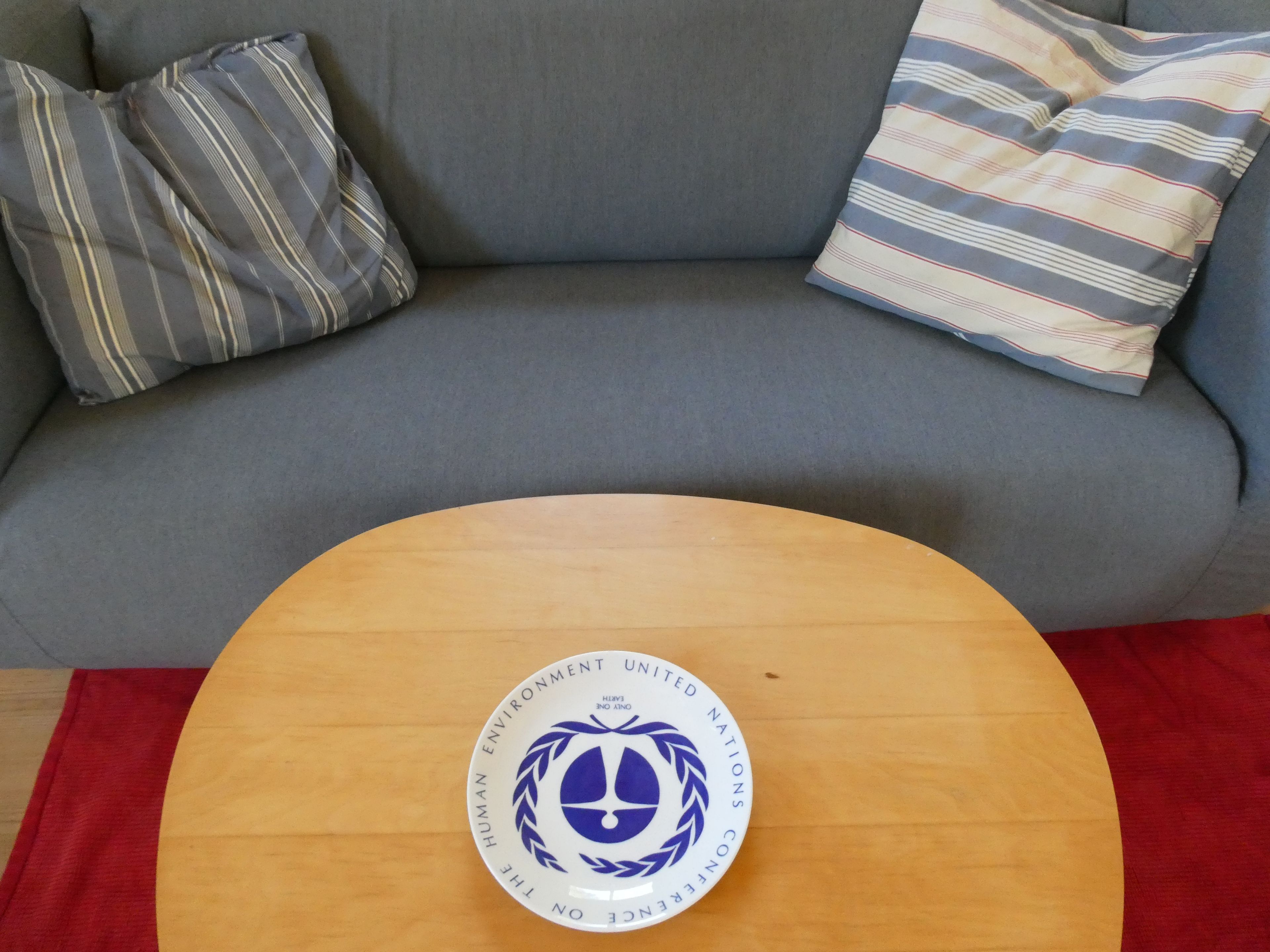 A round wooden table with a blue and white emblem in the center.