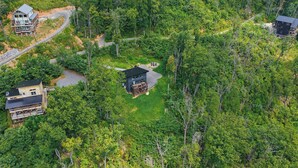 A forested area with multiple cabins and a winding road. - Indoor Pool, Hot Tub & Mountain Views Near Pigeon Forge (Sevierville)