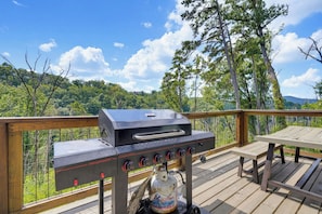 A wooden deck with a Megamaster grill and a gas tank. - Indoor Pool, Hot Tub & Mountain Views Near Pigeon Forge (Sevierville)