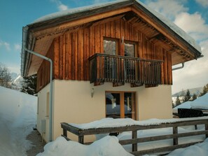 A wooden chalet with a balcony, surrounded by snow-covered ground. - Cabin in Annaberg With Swimming Pool (Annaberg-Lungoetz)