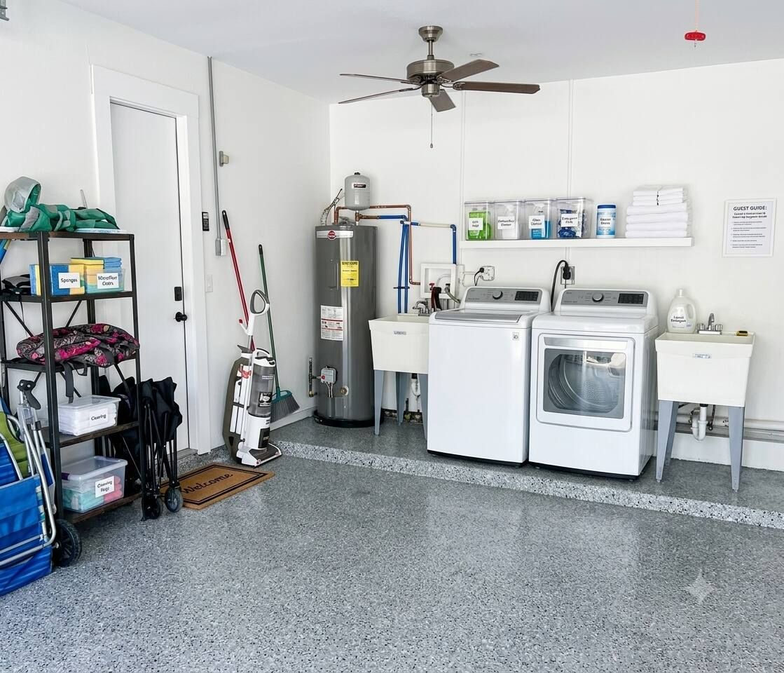 A laundry room with a ceiling fan, a water heater, and a washing machine.