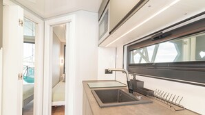 A modern bathroom with a sink, mirror, and shower area. - Vrbo Property (Lisboa)