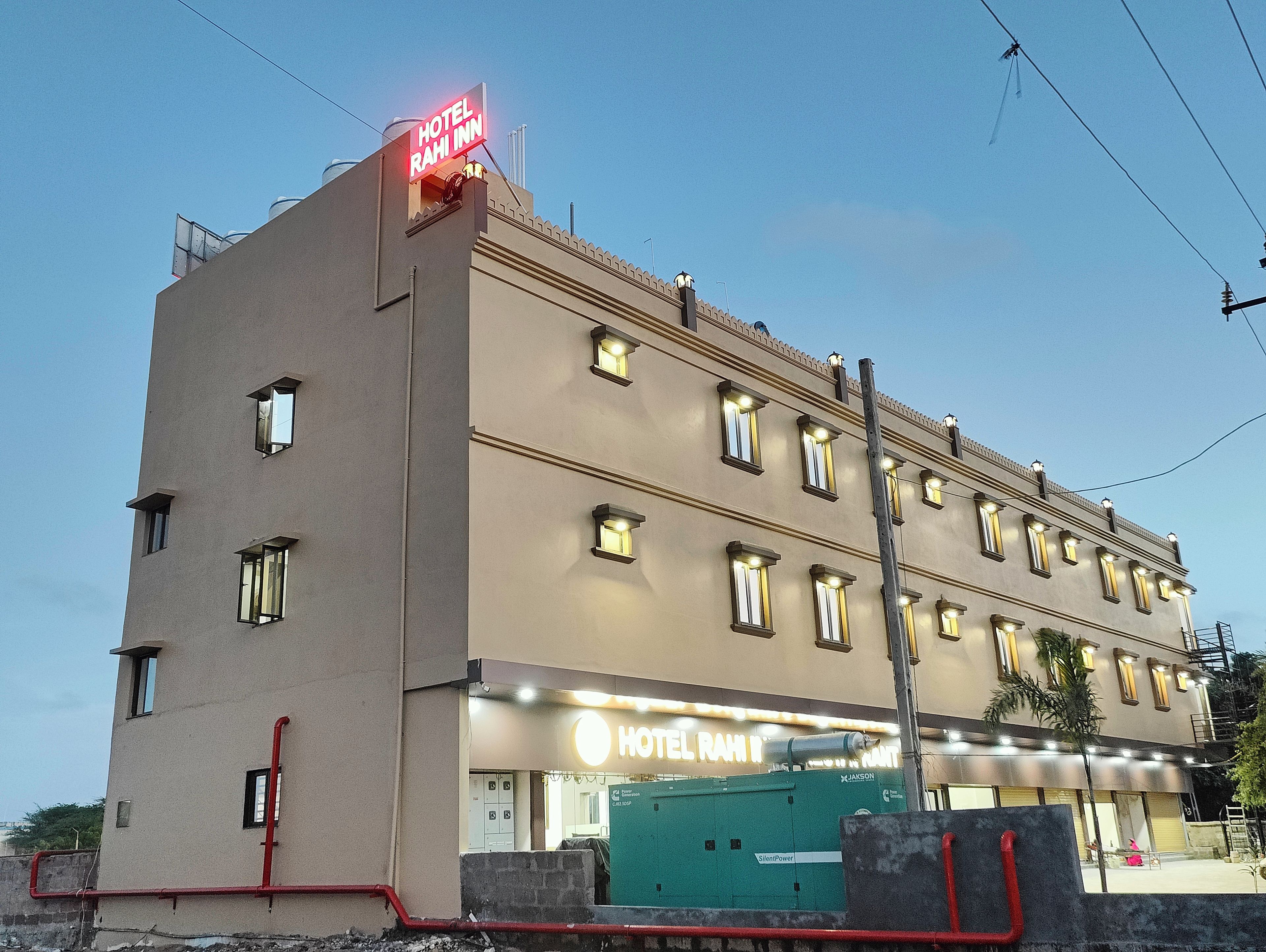 A multi-story hotel building with a prominent sign reading 'HOTEL RAHI INN' and a visible entrance.