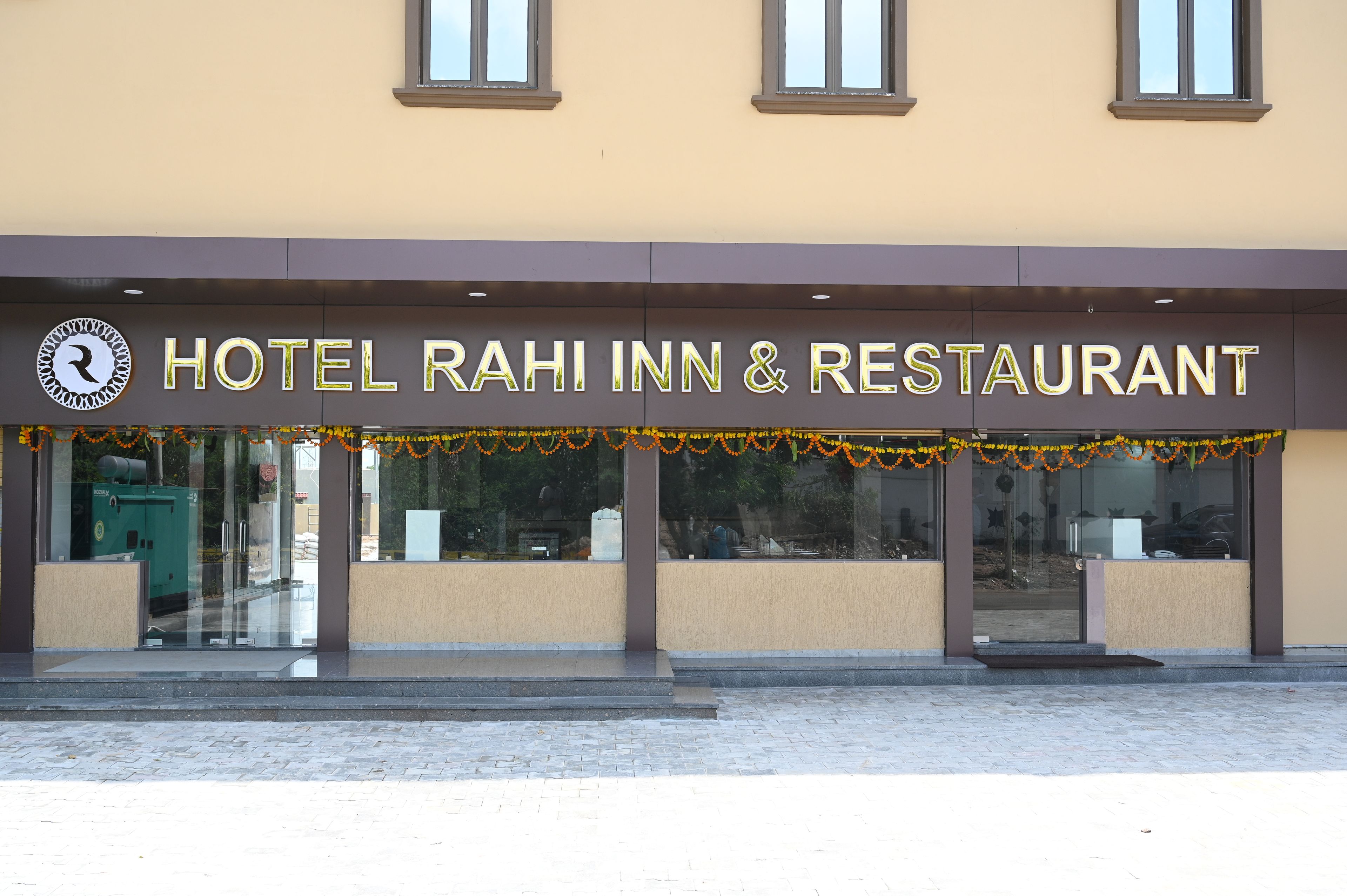 Un hôtel avec une enseigne indiquant « HÔTEL RAHI INN ET RESTAURANT ».