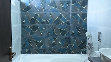 A bathroom with a bathtub, toilet, and sink.