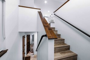 A staircase with wooden steps and a metal handrail. - Margaret Manor - South Lake Tahoe Retreat (South Lake Tahoe)