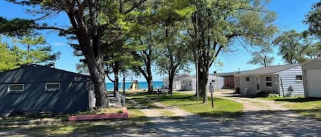 A campground with RVs and mobile homes, a paved path, and a clear sky.