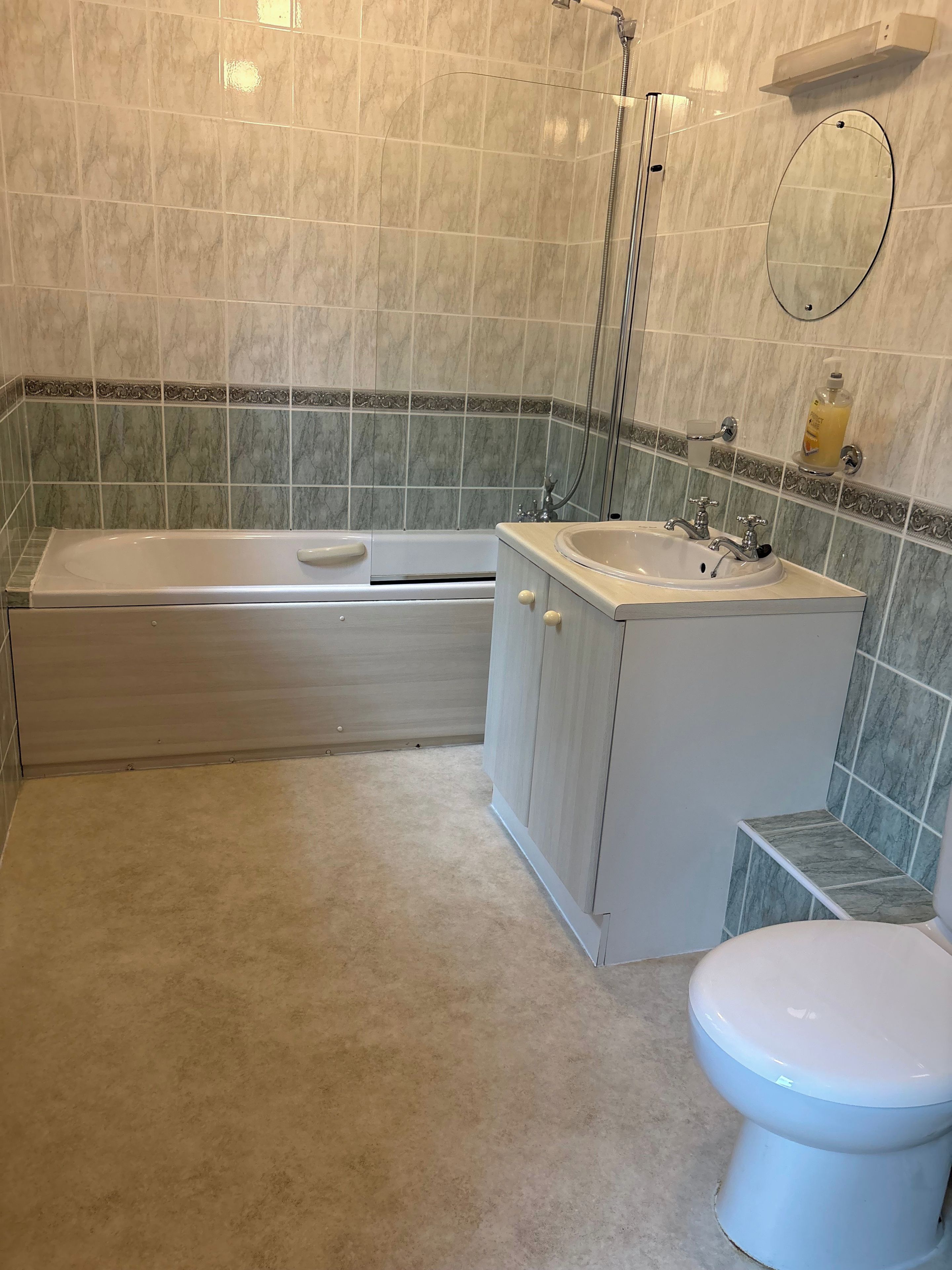 A bathroom with a bathtub, sink, toilet, and a shower.