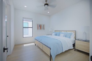 A bedroom with a bed, bedside tables, a window, and a ceiling fan. - *New* Naples Villa w/ Pool Jacuzzi | Sleeps 14 (Naples)