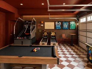 A pool table with balls, a basketball hoop, and two pinball machines in a room with a checkered floor. - NEW! Plaza Social House, GAME ROOM + walkable (Charlotte)
