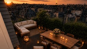 An outdoor patio with a sofa set, dining table, and chairs, surrounded by lanterns and plants. - 360° Rooftop, Paris Monuments & Eiffel View from Bed - Artist’s Apt (Paris)