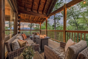 The covered deck has a fire table, string lights and serene mountain and forest views - Bear Bungalow | Mtn & Forest Views | Hot Tub (Sevierville)