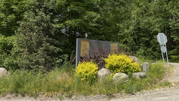 A sign with the word 'CHIC' in the center, surrounded by greenery and rocks.