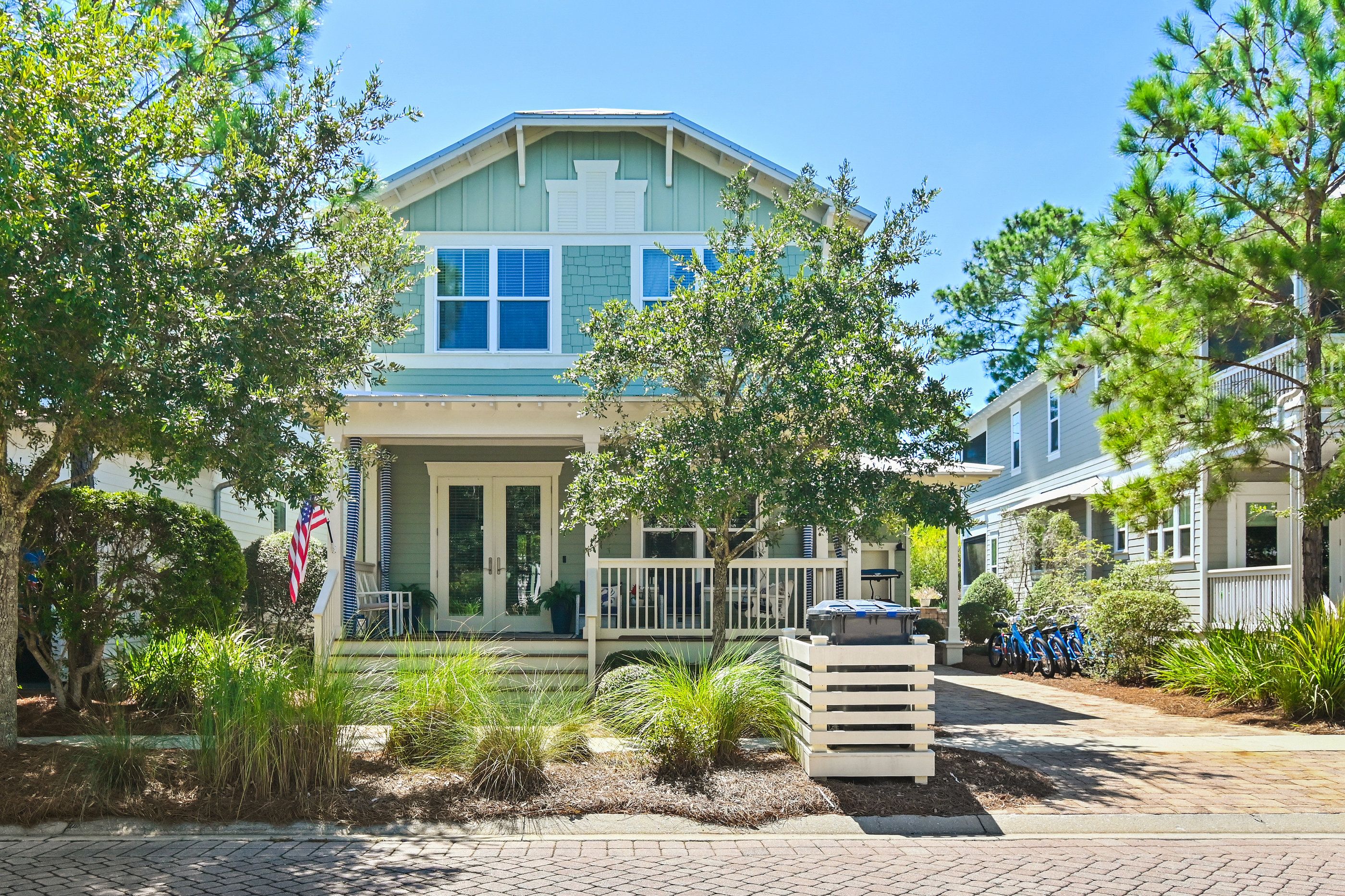 A two-story house with a porch, a garage, and a driveway.