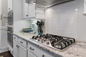 A kitchen with white cabinets, a stainless steel range, and a granite countertop. - 🌴Sea Esta | 4BR Coastal Retreat | Golf Cart + 6 Bikes | NatureWalk🌴 (Santa Rosa Beach)