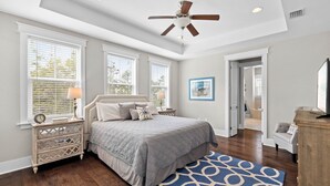 A bedroom with a bed, nightstands, a ceiling fan, and a large window. - 🌴Sea Esta | 4BR Coastal Retreat | Golf Cart + 6 Bikes | NatureWalk🌴 (Santa Rosa Beach)